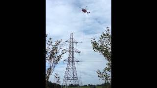 Inspecting power lines with  a helicopter