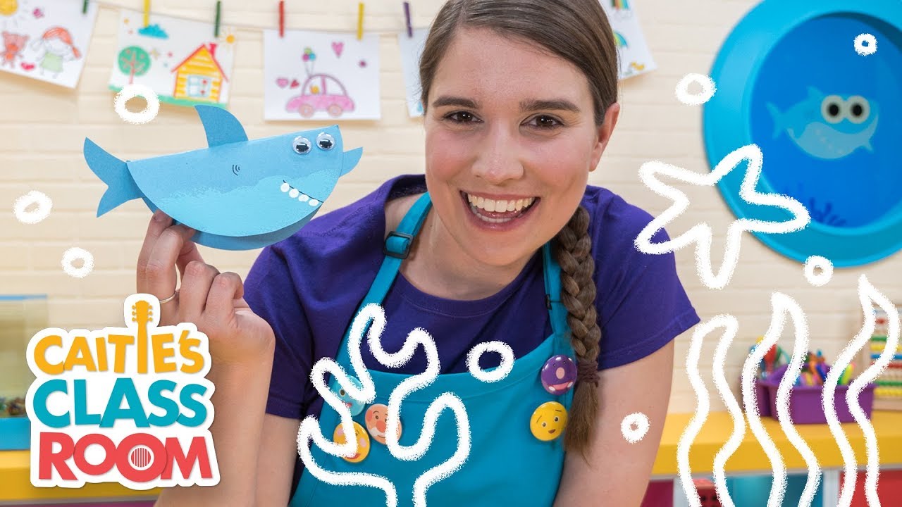 Caitie's Classroom Live - Baby Shark! - In today’s show, Caitie will be talking about family, singing 10 Little Fishies, making a Baby Shark craft, and taking a special visit to the aquarium where she