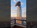 Distant View: Building Collapses Under Heavy Missile Strike Captured on Camera