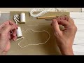 Transferring beads and sequins onto the working thread for embroidery with the Luneville hook.