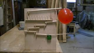 rube goldberg machine, science project. Dominoes falling in slow motions.