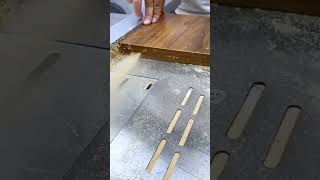 Cutting and trimming a wooden board using a table saw machine to achieve a smooth finish