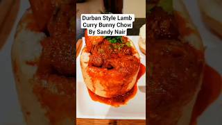 Lamb Curry & potatoes filled in the cavity of an unsliced white bread loaf with carrot salad.