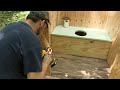 Building an outhouse at a remote off-grid wilderness camp