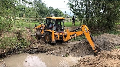 JCB Backhoe Loader Is Preparing To Build A Bridge In A Remote Village - JCB Bridge Foundation
