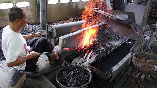 Thai Blacksmith Making Traditional Thai Dhab Swords in Lampang, Thailand