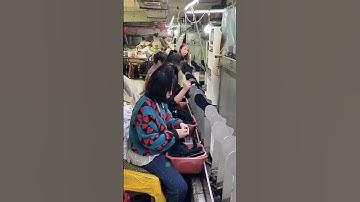 Workers place the knitted socks on the shaping rack to shape them.