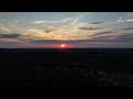 Rising above the trees to a beautiful sunset