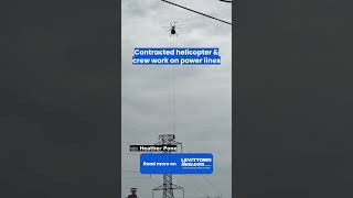 Helicopter Carries Worker To Power Transmission Tower