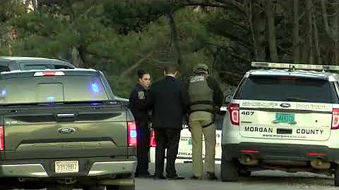 Law enforcement surrounds house with Daniel Miner ...