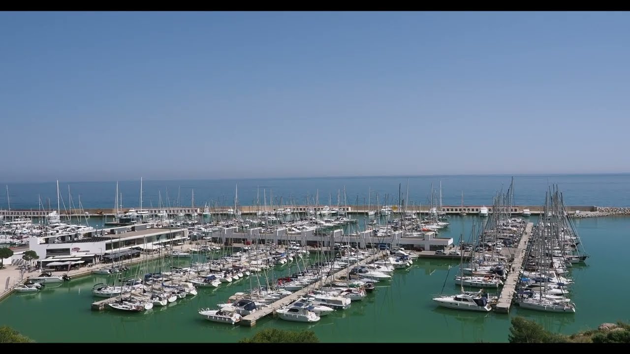 Sailing boat entering port. Spain, Port Ginesta.