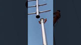 Electricians Installing High Voltage Power Lines On Utility Poles