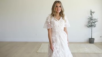 Timelessly modest bridal gown with flutter sleeves.