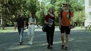 STUDENTS WALKING THROUGH A COLLEGE