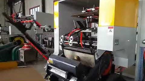 Creasing and die cutting machine with robotic hand and stacker