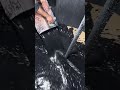 This is a special black liquid that is being poured into a large container