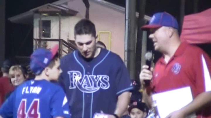 Teddy Flynn recieves a sighned Major League Baseba...