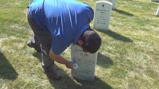 Volunteers clean headstones at Rock Island National Cemetery to honor 9/11 victims and veterans