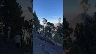 Person Hiking Up While Witnessing A Volcanic Eruption