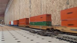 Slow HO scale CSX intermodel train passes a DT&I grain express train all athearn engines