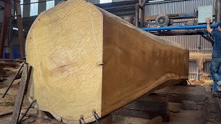 The process of operating a giant wood cutting machine at the factory