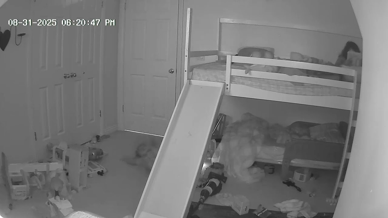 Little girl jumps on top of bunk bed than trips over guard rail and falls (Security camera)