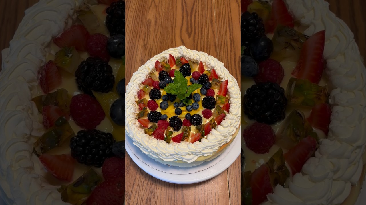 Cheesecake topped with pineapple curd, whipped cream, and a variety of fruits!