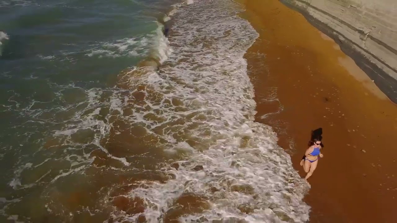 Beach bikini woman carefree running along the water on the beach picturesque sea co [4K]