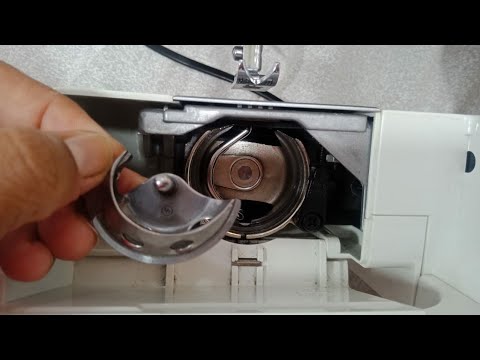 How do I insert the bobbin case in the machine?