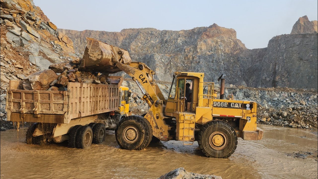 Power and Precision of Caterpillar 966E Wheel Loader: Loading Stone into Dump Trucks