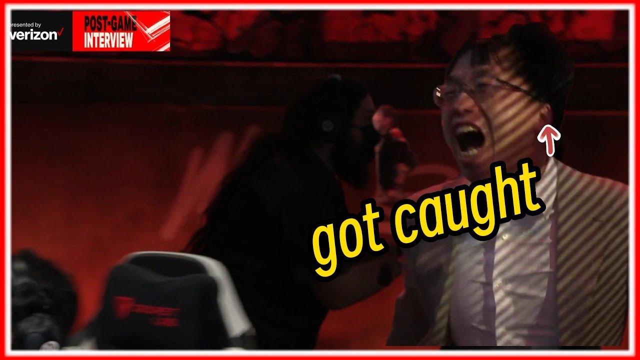 BLG head coach getting tackled by referee after running out on stage to celebrate their win.