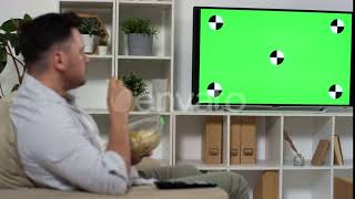 Man Eating Chips and Watching Green Mock-Up Screen TV | Stock Footage - Envato elements