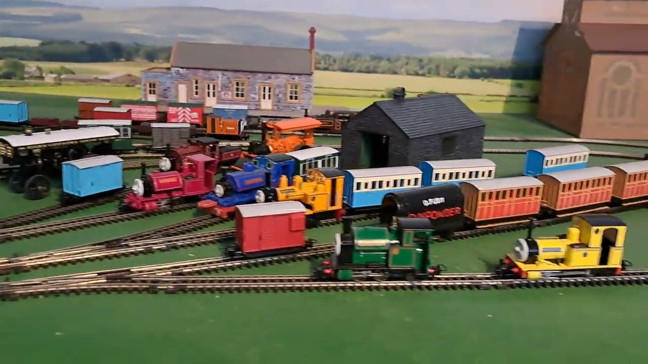 Bachmann Rusty pulling 2 brown 2 red slate wagons, red box van and blue brakvan 