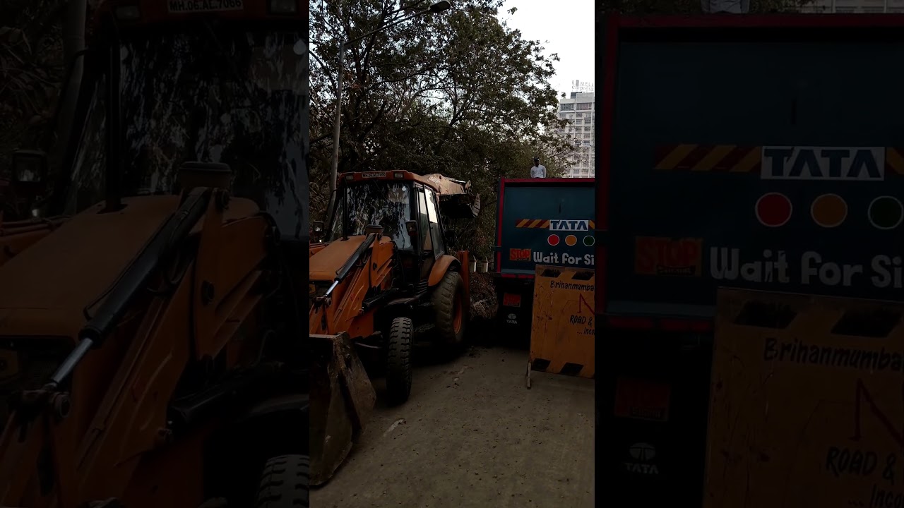 Excavator putting mud in truck 