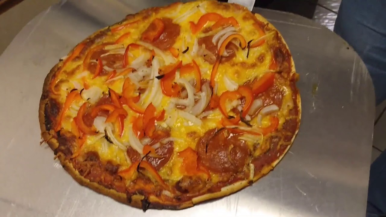 Thin crust homemade tortilla pizza! Pepperoni, onion, pepper, from