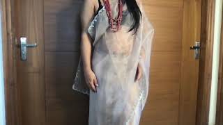 Sexy saree wrapped bhabhi in a net transparent saree without bra