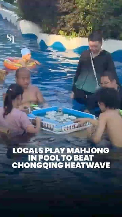 Locals play mahjong in pool to beat Chongqing heatwave