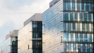 Beautiful time lapse of the cloudy sky reflected in the Windows of a skyscraper
