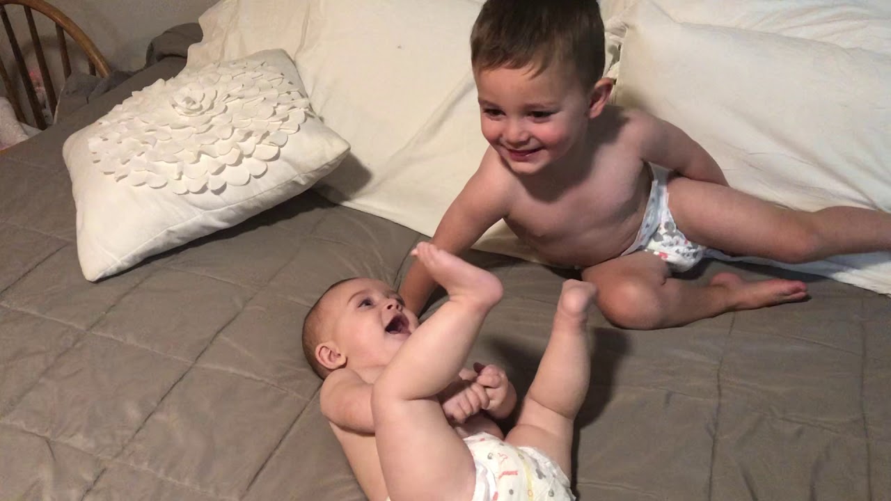 Toddler Blowing Raspberries on the Baby