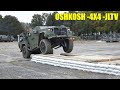 Oshkosh 4x4 jltvdriving over an obstcle