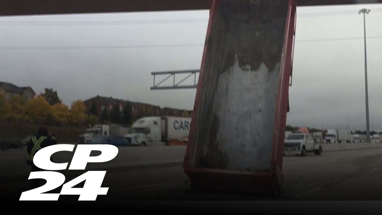 Dump truck strikes overpass on Highway 401 - YouTube