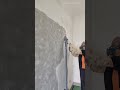 Sanding the concrete wall to smooth the surface using an electric wall sander machine with vacuum