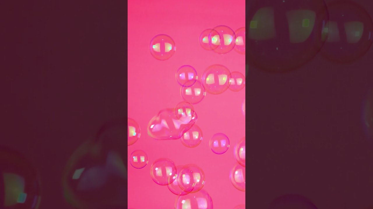 Bubbles floating on a pink background