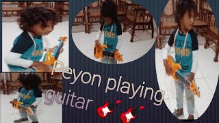 Peyon Playing Guitar