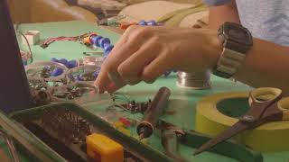 Taiwan technician cyber cool workflow mixing electronic components together using amateur soldering