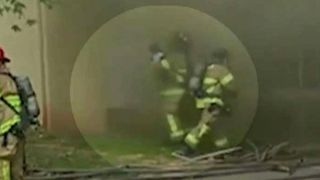Hero firefighter catches baby dropped from burning building
