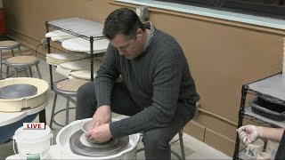 Keith Kaiser tests out a pottery wheel at the Intro to Glass Mosaics class