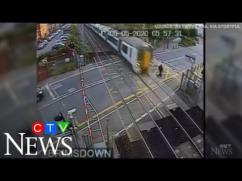 Caught on cam: Reckless pedestrian nearly hit by train