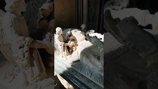 A tomb with a carved corpse!