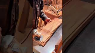 Professional worker cutting wood sheets using an industrial table saw machine